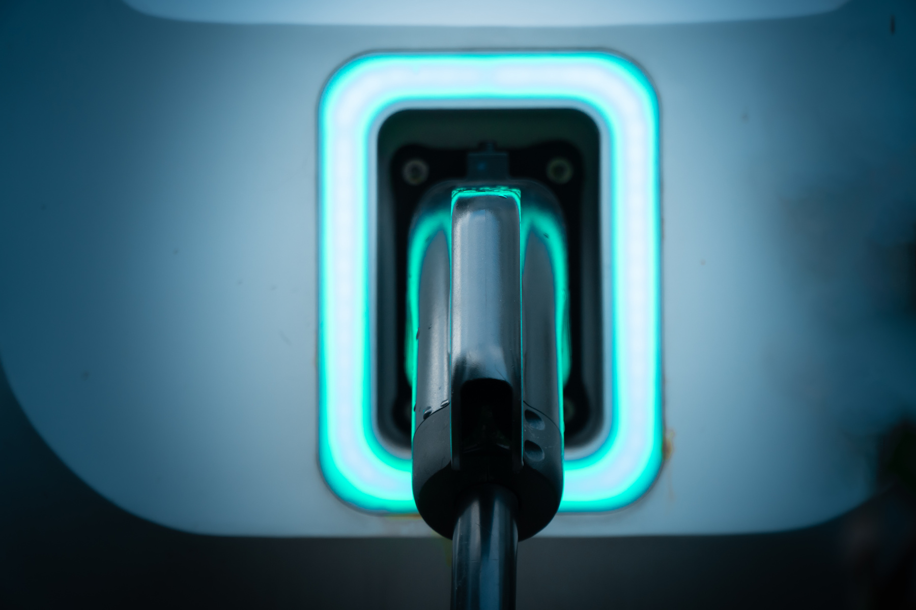 Power supply of EV charging station with cable, charging port at an electric vehicle charging station